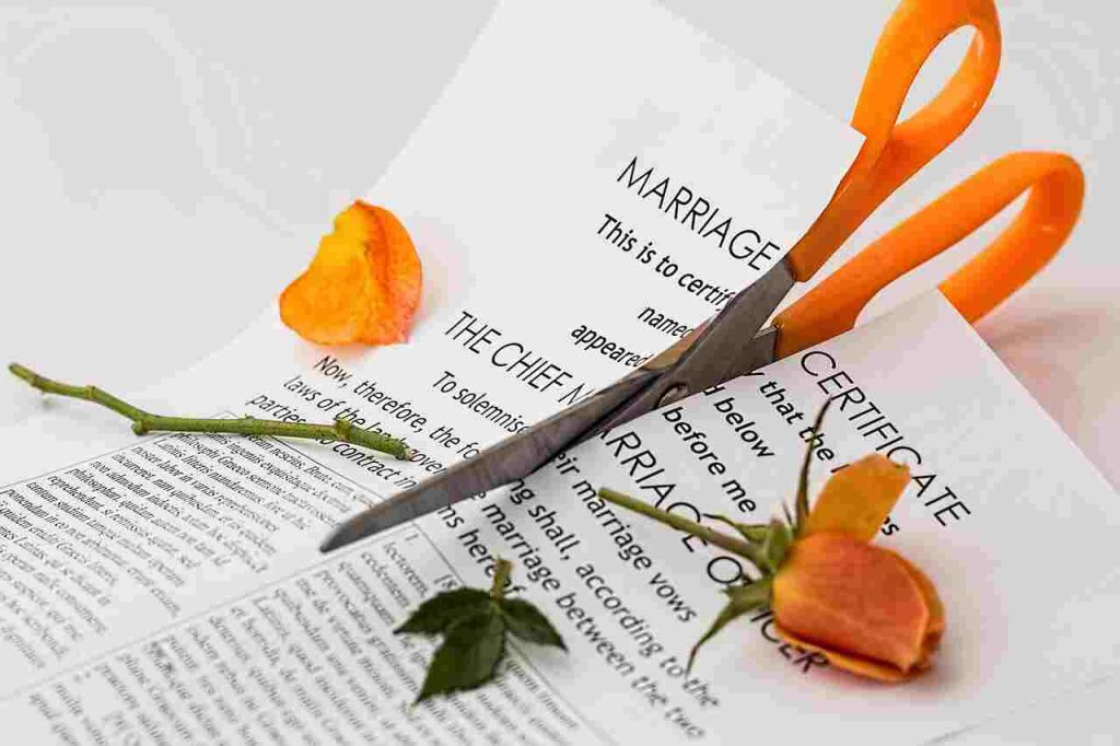 Couple sitting apart at a table — reflecting on the Apostle Paul's teaching on divorce and the Pauline Privilege